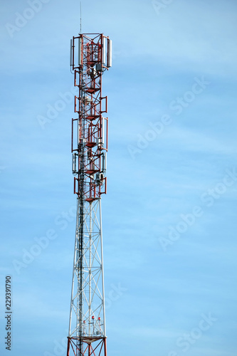 Top section of high communication tower with antennas on the top vertical photo