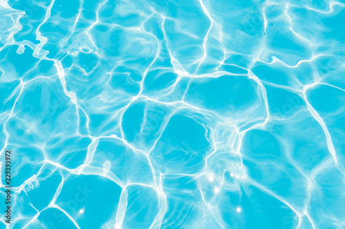 Fototapeta Blue and bright water in swimming pool with sun reflection, Motion of ripple wat