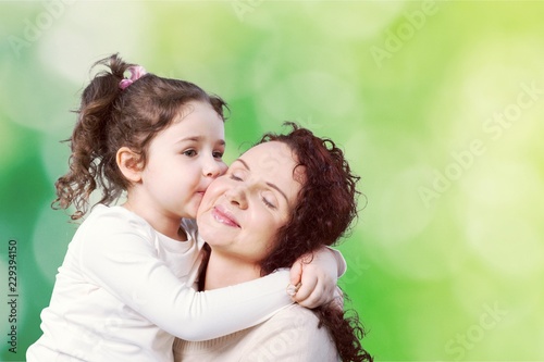 Happy Mother and daughter together with flowers