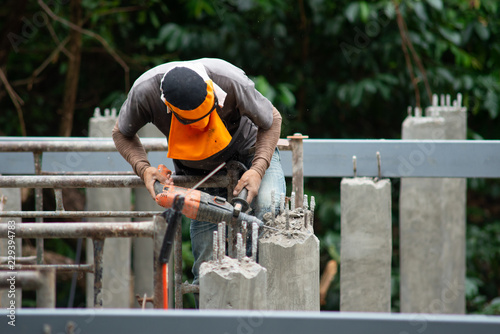 Workers are using Impact drill to drill concrete..