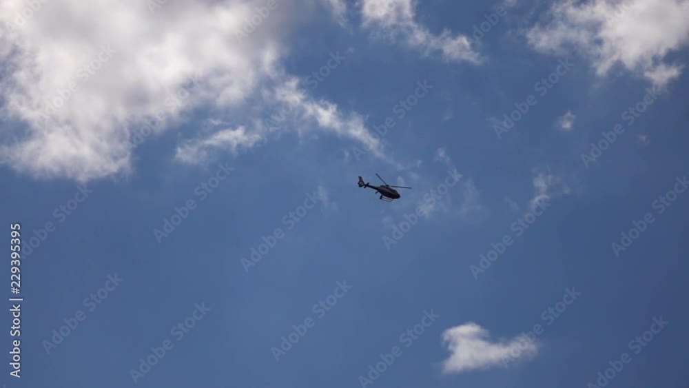 Helicopter in blue sky. Slow motion. Helicopter in blue sky. Slow motion.