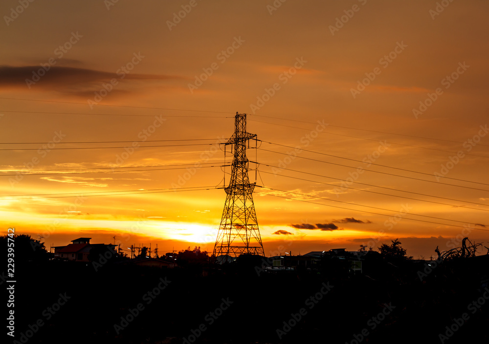 High voltage pylons on the evening sunset, silhouette