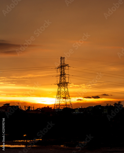 High voltage pylons on the evening sunset, silhouette