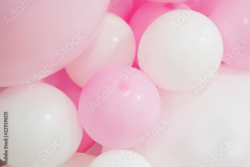 blurred background - white and pink balloons of different sizes