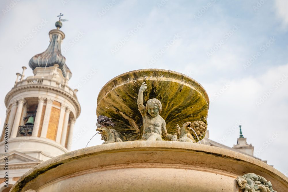 Fototapeta premium Fountain next to Loreto Basilica della Santa Casa in sunny day in Italy