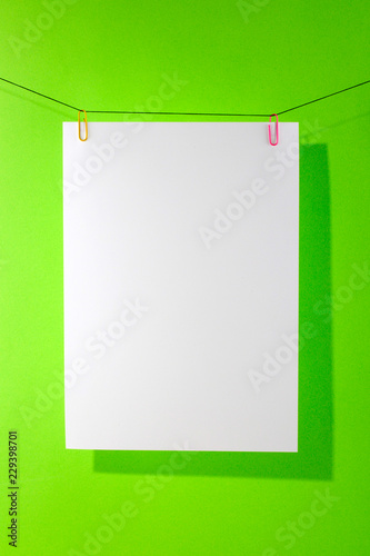 Sheet of white paper on a green background for decoration, for text design, for a template