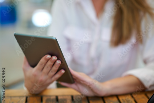Close-up of woman using tablet. Businesswoman outdoor concept.