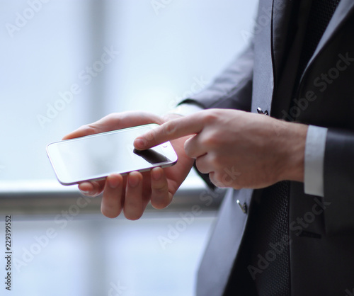 close up.a businessman uses a smartphone.people and technology