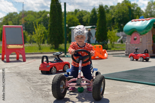 A little girl in a white hat playing on the Playground on a Sunny day.