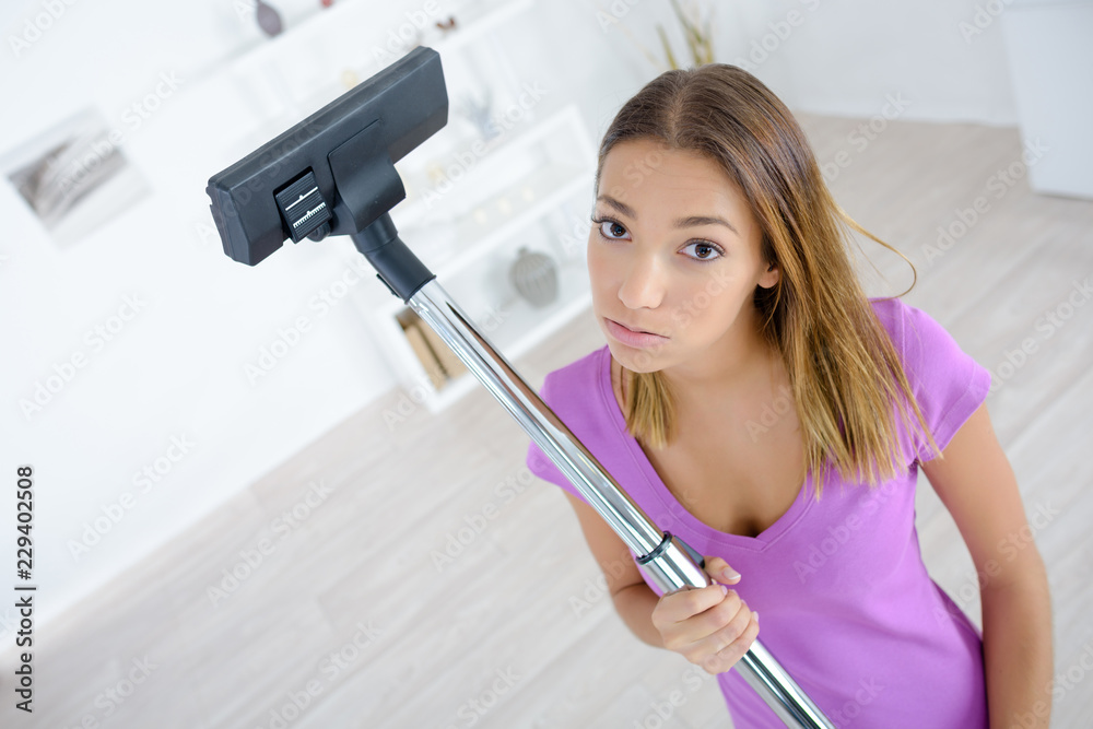 young woman tired of doing cleaning at home