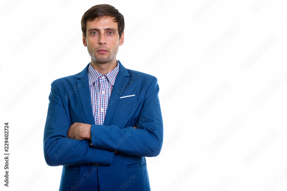 Studio shot of young handsome businessman with arms crossed Studio shot of young handsome businessman with arms crossed