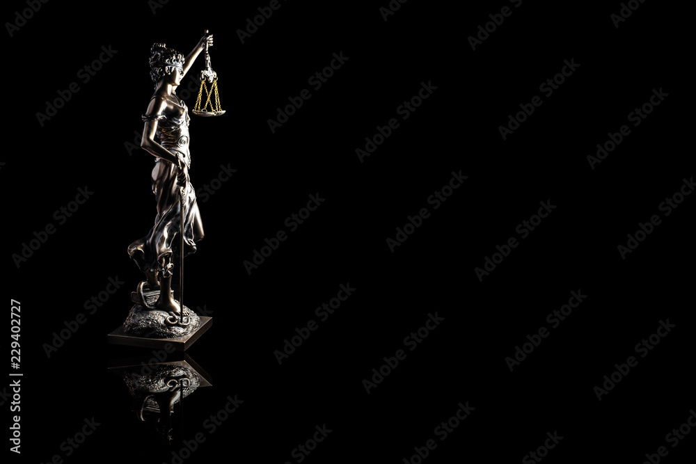 Lady justice or Themis with reflection isolated on black background and space for text