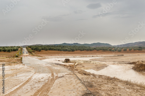 Cut road by muddy flood after historic storm in Seville and Málaga that caused the overflow of rivers and streams