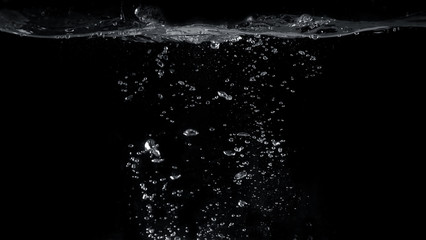 Blurred images of close-up soda water bubbles fizzing up or splashing or sparkling like a exploding of a bomb on black background for represent refreshing from carbonated drinks menu.