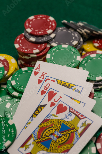 Casino chips and poker cards on green table