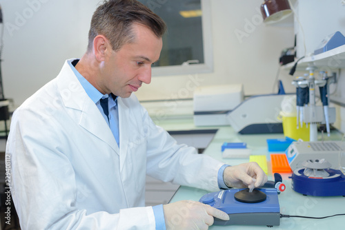 Laboratory technician setting up equipment