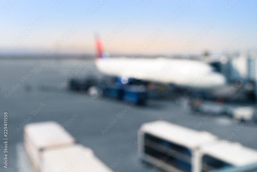 Fototapeta premium Airplane at airport terminal boarding gate. Blurred out of focus.