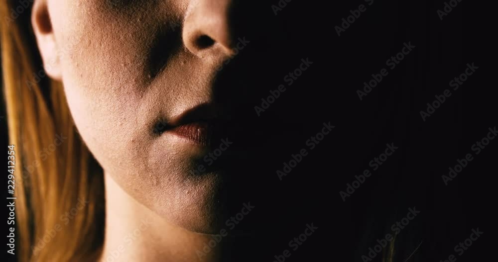 Seriouse woman placing her finger on lips Seriouse woman placing her finger on lips