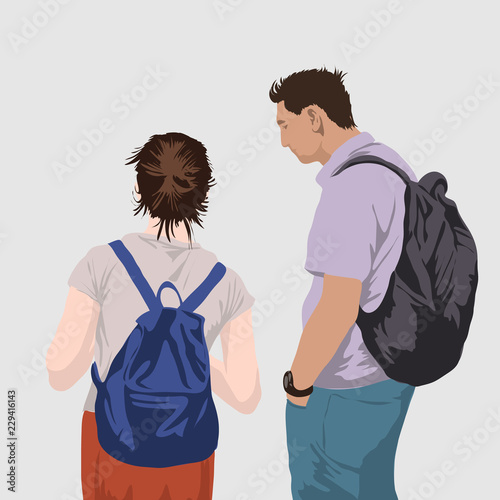 a young couple looks at an object or communicates. man and woman rear view.