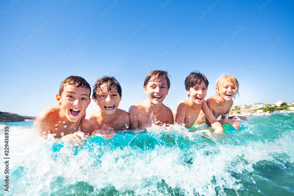 Five happy friends swimming on air mattress Five happy friends swimming on air mattress