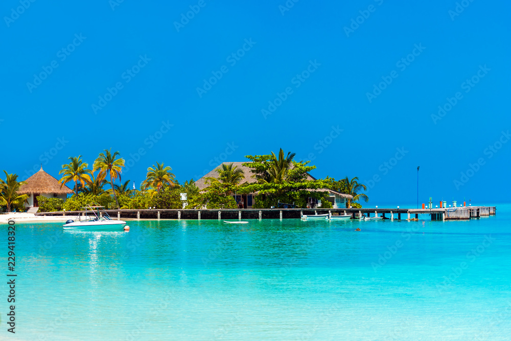 Water villa in a row by the seashore, Maldives. Copy space for text.