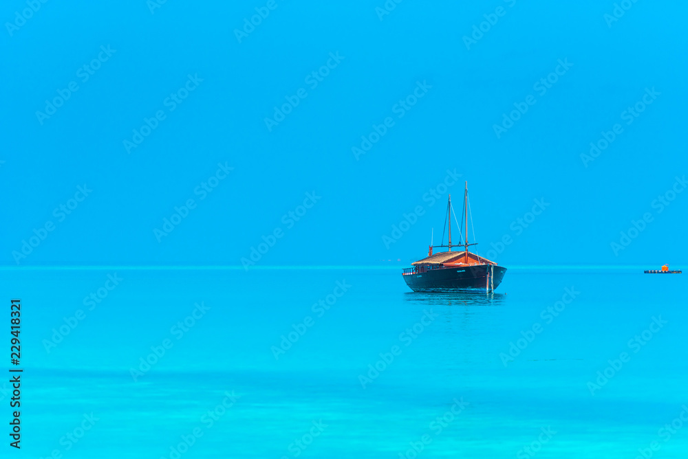 Boat off the coast of the island, Maldives. Copy space for text.