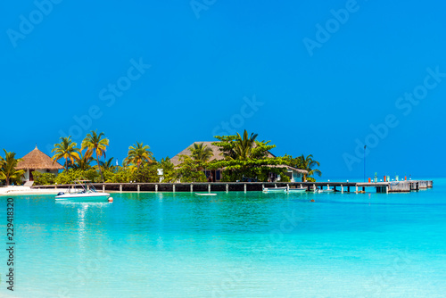 Fototapeta Naklejka Na Ścianę i Meble -  Water villa in a row by the seashore, Maldives. Copy space for text.