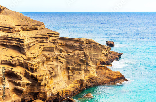 View of the rocks on the beach Papakolea (green sand beach), Hawaii, USA. Copy space for text. photo