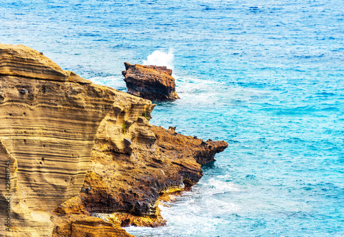 View of the rocks on the beach Papakolea (green sand beach), Hawaii, USA. Copy space for text. photo