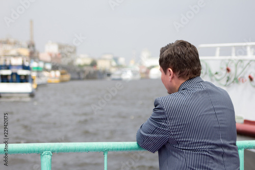 man back looking distance blur summer river city