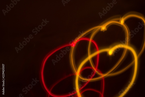 heart-shaped lights night blurred red and orange neon bokeh on dark background