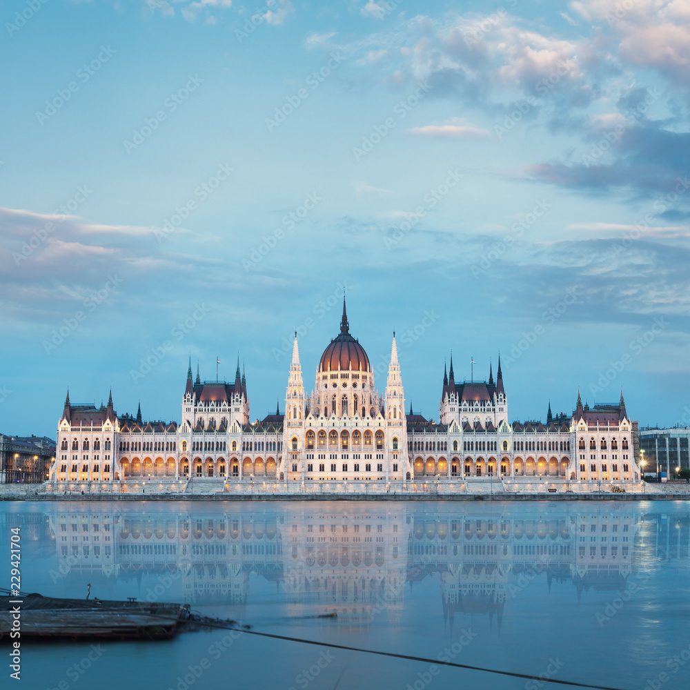 Parliament building in Budapest, Hungary. Building facade with reflection in water. Beautiful picture at sunset