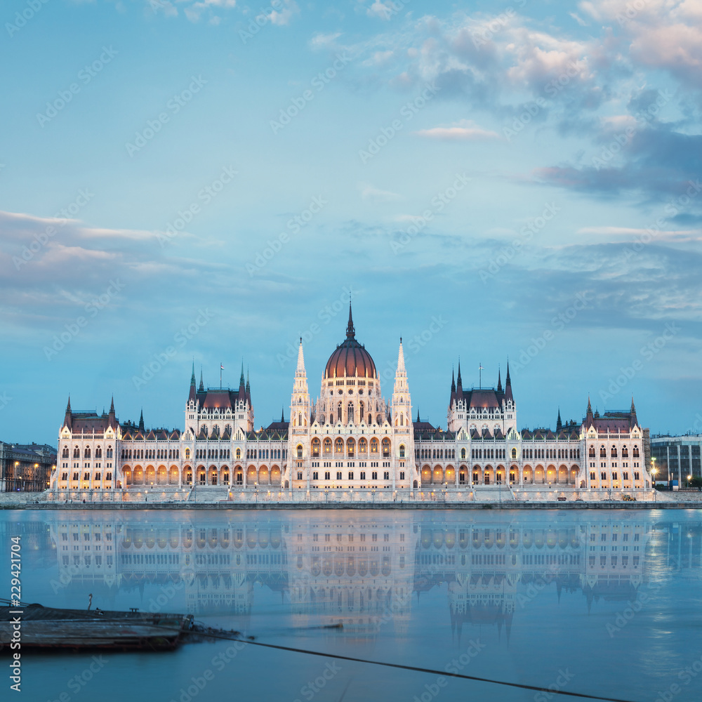 Parliament building in Budapest, Hungary. Building facade with reflection in water. Beautiful picture at sunset Parliament building in Budapest, Hungary. Building facade with reflection in water. Beautiful picture at sunset