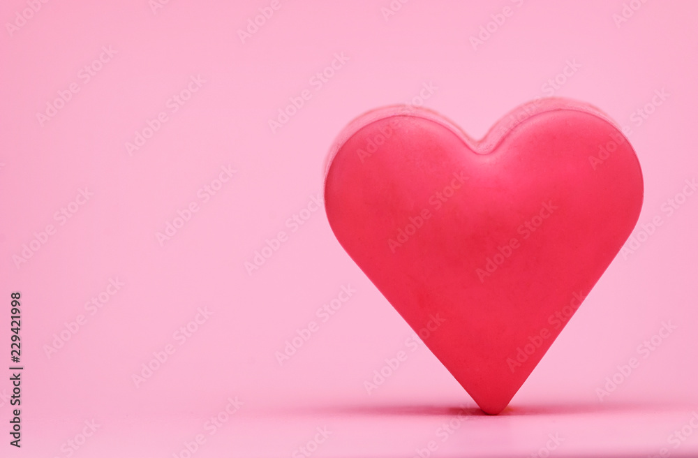 Red heart on a pink background, front view