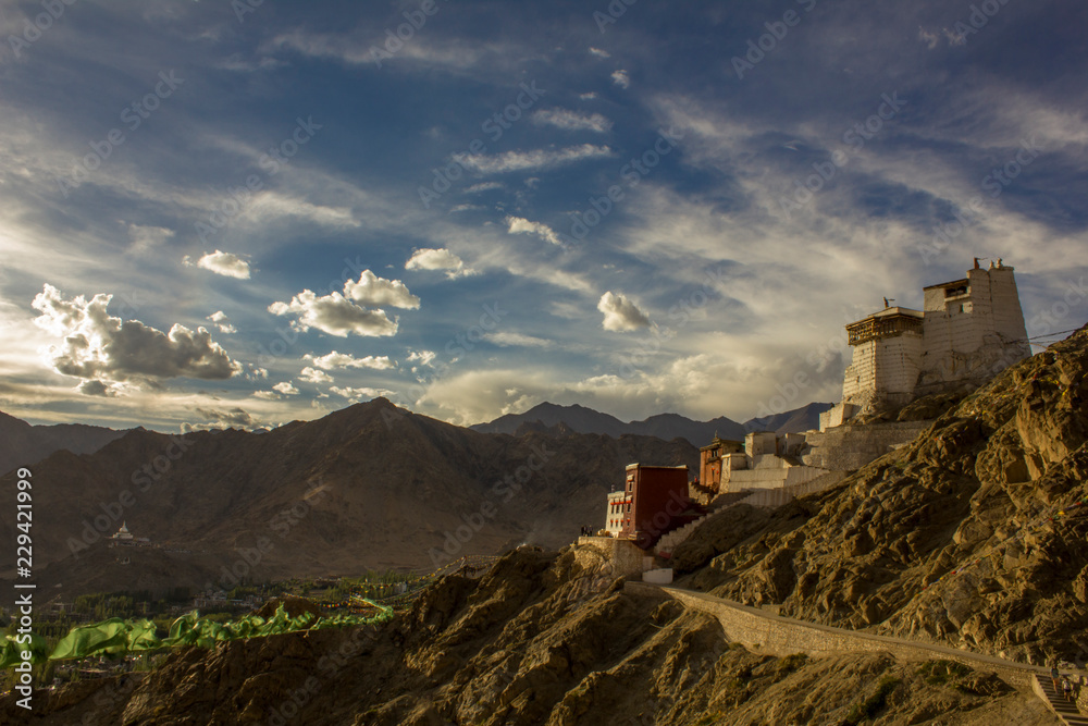 Tibetan temple on the mountain in the rays of the setting sun