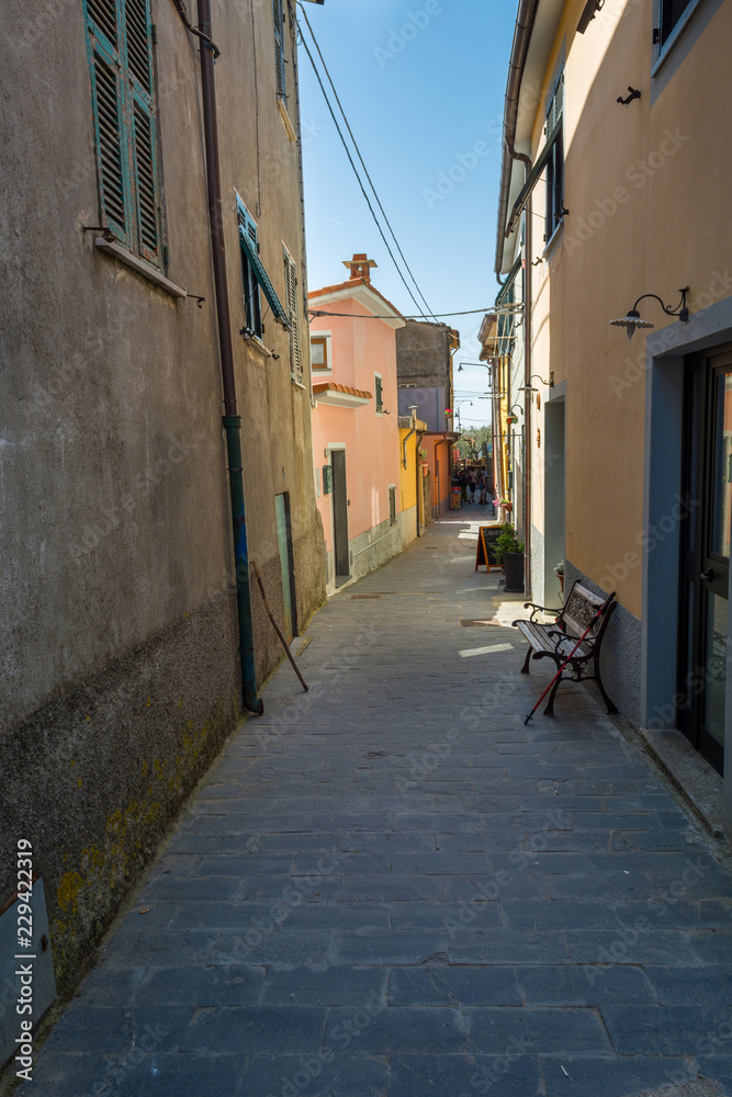 Fototapeta premium Manarola, Italy - April 29: Tourists exploring picturesque alleys of medieval town, on April 29 2018 in Manarola, Italy