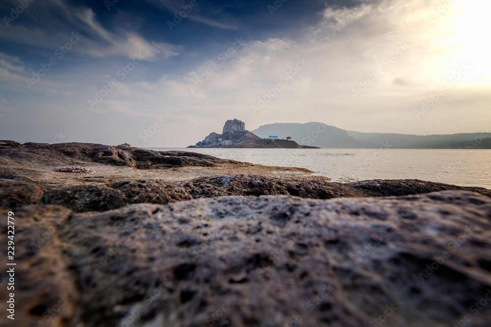 Obraz premium Kos island, Greece, coast view of Kefalos village, island of Kastri and an orthodox temple at sunset