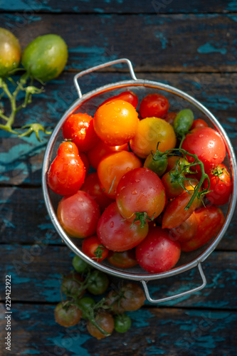 Fresh tomatoes on rustic background