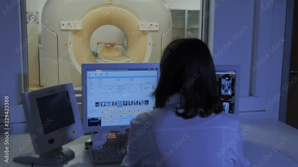 Nurse doing computed tomography to the patient Nurse doing computed tomography to the patient