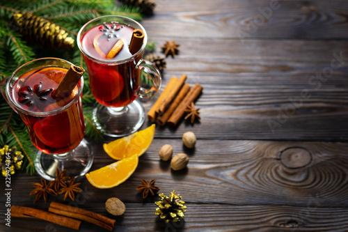 Cups of mulled wine on table with spices