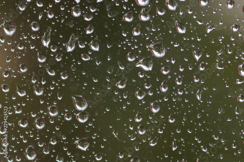 Drops of rain on the window glass on a blurred background. Selective focus.