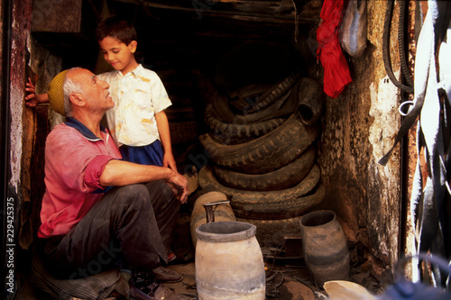 Grandfather and grandson in a repair shop.