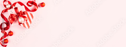 Christmas gift on pink background.