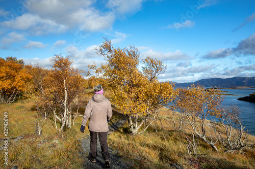 Woman walking in autumn forest © Gunnar E Nilsen