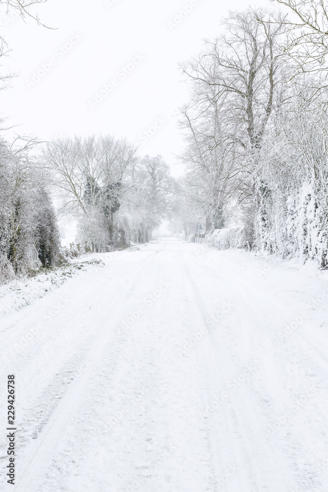 Country road covered in snow in winter