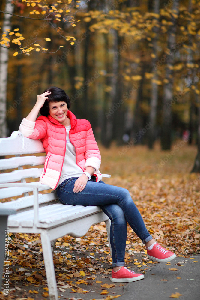Girl on a bench in the autumn park. Girl on a bench in the autumn park.