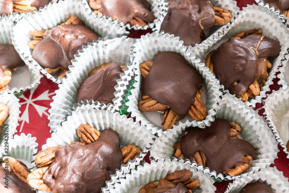 Pile of chocolate, caramel and pecan homemade turtles candies