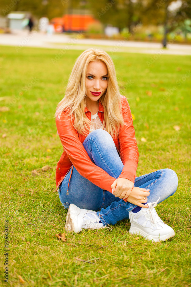 Fototapeta premium Young blonde woman in blue jeans