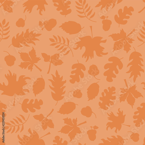 Fall leaves seamless vector background. Orange leaf silhouettes on light orange. Acorns, oak tree, maple tree pattern. Subtle autumn print. Fall background, Thanksgiving, Seasonal print, November