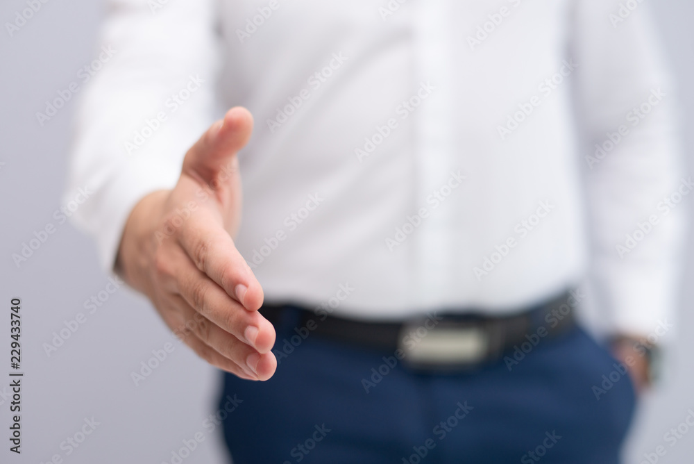 Close-up of businessman stretching hand for handshake. Caucasian manager greeting client or partner. Partnership concept Close-up of businessman stretching hand for handshake. Caucasian manager greeting client or partner. Partnership concept
